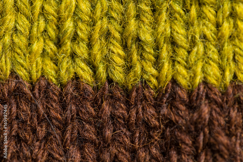 A beautiful closeup of a hand knitted warm and soft wool pattern. Soft socks or scarf of natural wool. Colorful pattern. A beautiful closeup of a hand knitted warm and soft wool pattern. Soft socks or scarf of natural wool. Colorful pattern.