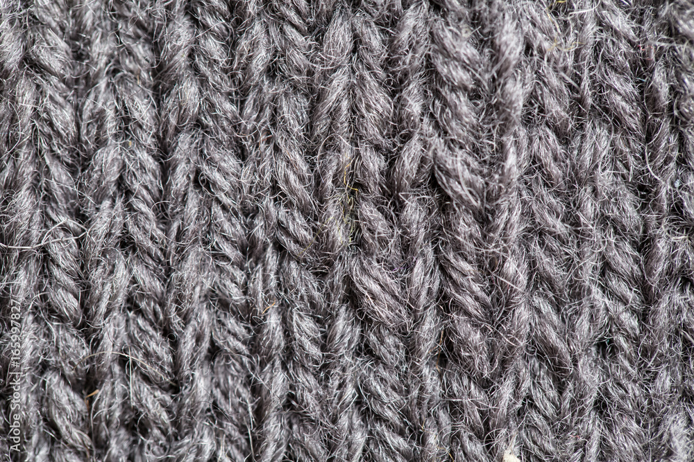 A beautiful closeup of a hand knitted warm and soft wool pattern. Soft socks or scarf of natural wool. Colorful pattern. A beautiful closeup of a hand knitted warm and soft wool pattern. Soft socks or scarf of natural wool. Colorful pattern.