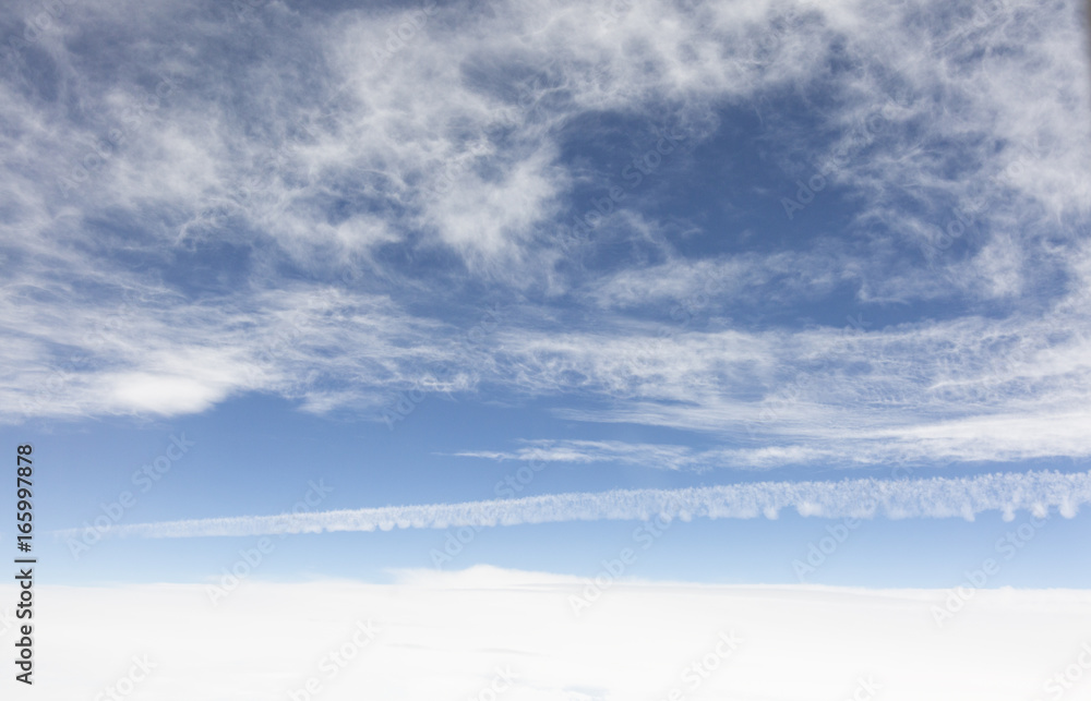 Fototapeta premium the sky when i am looking through window aircraft during flight in wing with a blue sky.