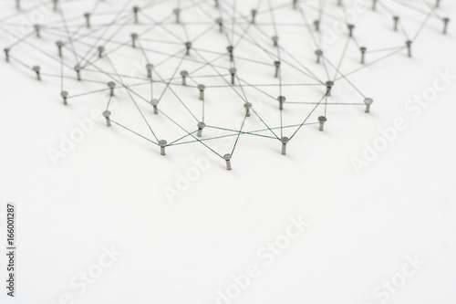 Linking entities. Network, networking, social media, internet communication abstract. A small network connected to a larger network. in paper linked together by cotton with a black tint