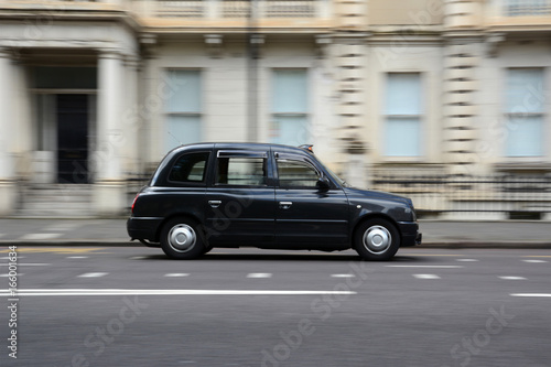 Panning shot of a black taxi in London.