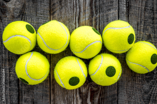 Sport background. Tennis balls on wooden background close up top view © 9dreamstudio