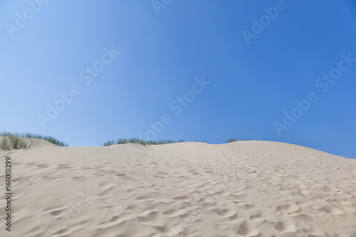White sand dunes, Nida, Lithuania. Beautiful landscape with blue sky