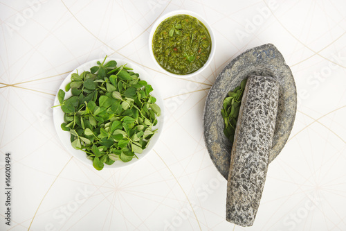 Green Methi or Fenugreek with Mortar and Pestle photo