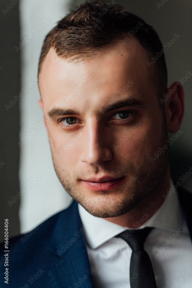 Young attractive and confident businessman in blue suit and black tie. Young attractive and confident businessman in blue suit and black tie.