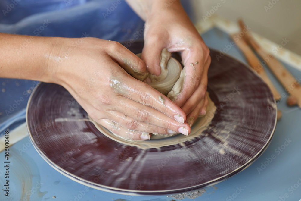 Creating jar or vase of clay. Woman hands, potter's wheel Creating jar or vase of clay. Woman hands, potter's wheel