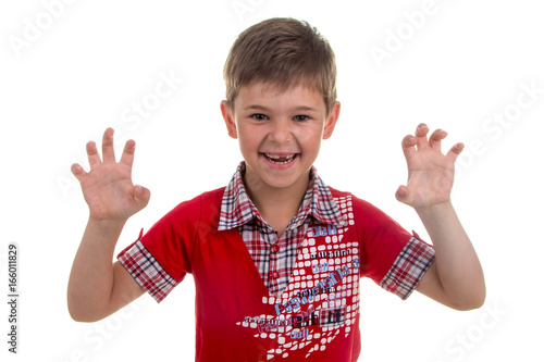 Portrait of emotionally kid, roaring like a lion on white background