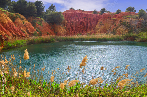 The lake in a old bauxite's quarry in Apulia, Otranto, Salento, Italy.The digging was filled with natural waters. A small lake ecosystem has thus been created, example of spontaneous renaturalization. photo