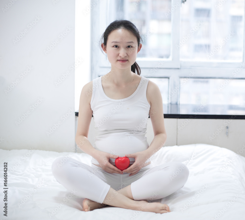 Pregnant woman relaxing at home on the couch Pregnant woman relaxing at home on the couch