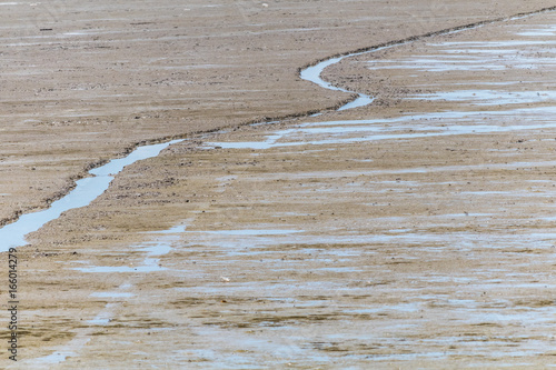 Small river on the sand after low tide 