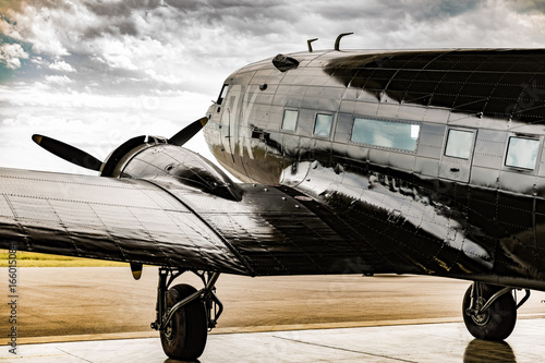Canvas Print A World War II plane looks out from its hanger waiter for the weather to clear