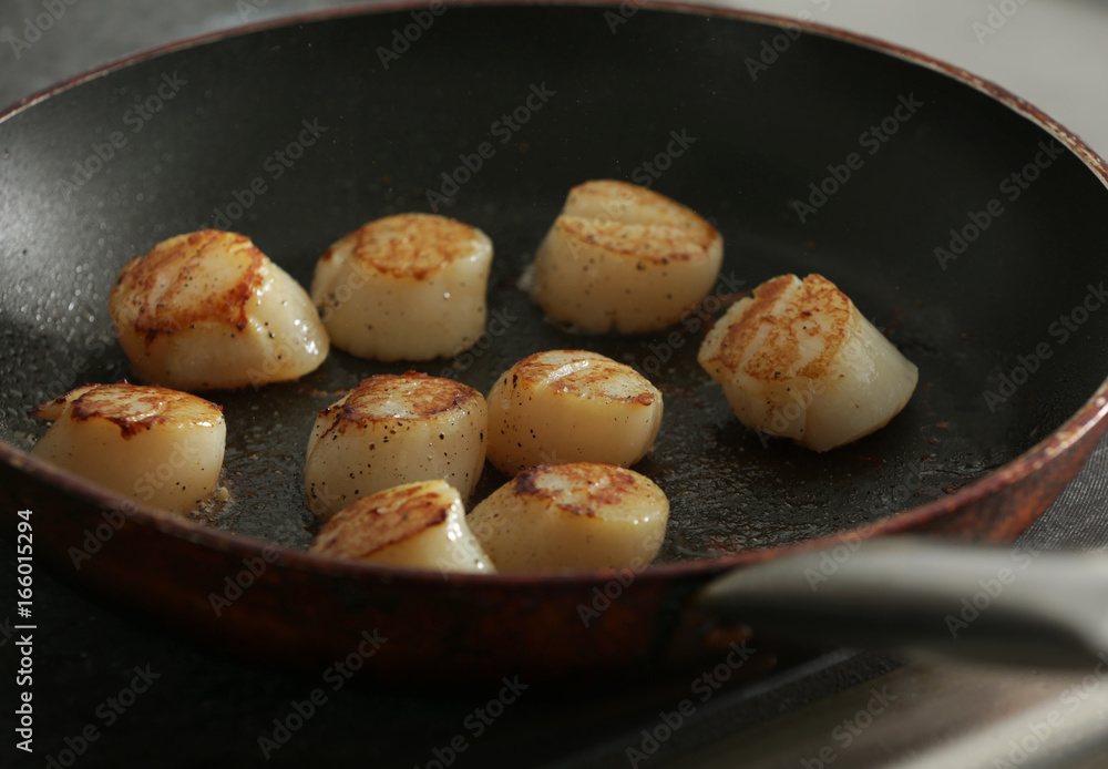 Frying pan with delicious scallops, closeup Frying pan with delicious scallops, closeup