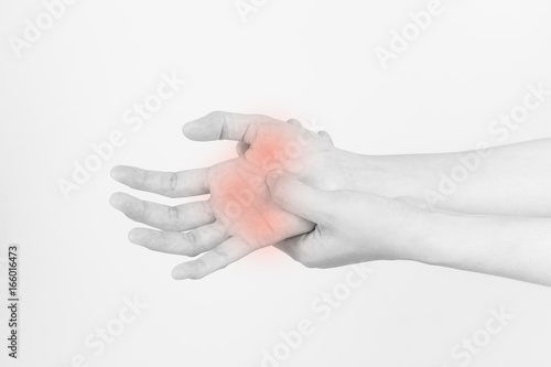 The hands of the girl with pain,Carpal Tunnel Syndrome from work,Black and white picture of hand pain highlighted by red dots