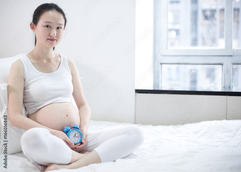 Pregnant woman relaxing at home on the couch Pregnant woman relaxing at home on the couch