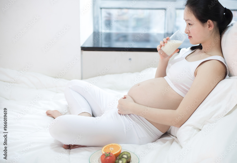 healthy nutrition and pregnancy. pregnant woman's belly and vegetable salad healthy nutrition and pregnancy. pregnant woman's belly and vegetable salad