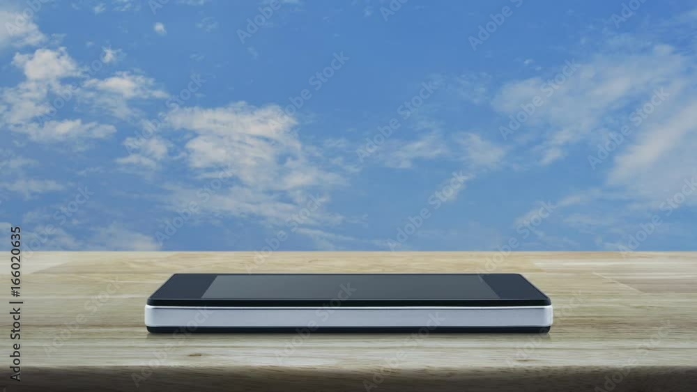 Map pin location button on modern smart phone screen on wooden table over blue sky with white clouds, Map pointer navigation concept Map pin location button on modern smart phone screen on wooden table over blue sky with white clouds, Map pointer navigation concept
