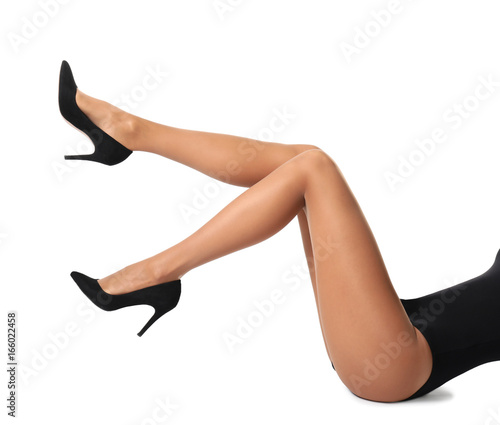 Legs of beautiful young woman in tights on white background