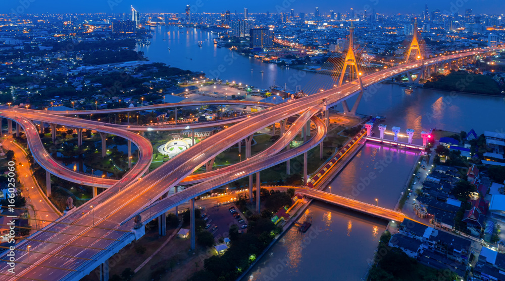 Top view over the highway,expressway and motorway at night, Aerial view interchange of a city, Shot from drone,Expressway is an important infrastructure in Thailand Top view over the highway,expressway and motorway at night, Aerial view interchange of a city, Shot from drone,Expressway is an important infrastructure in Thailand