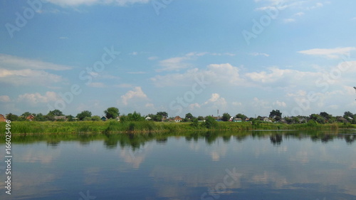 Houses on the river bank under the blue sky