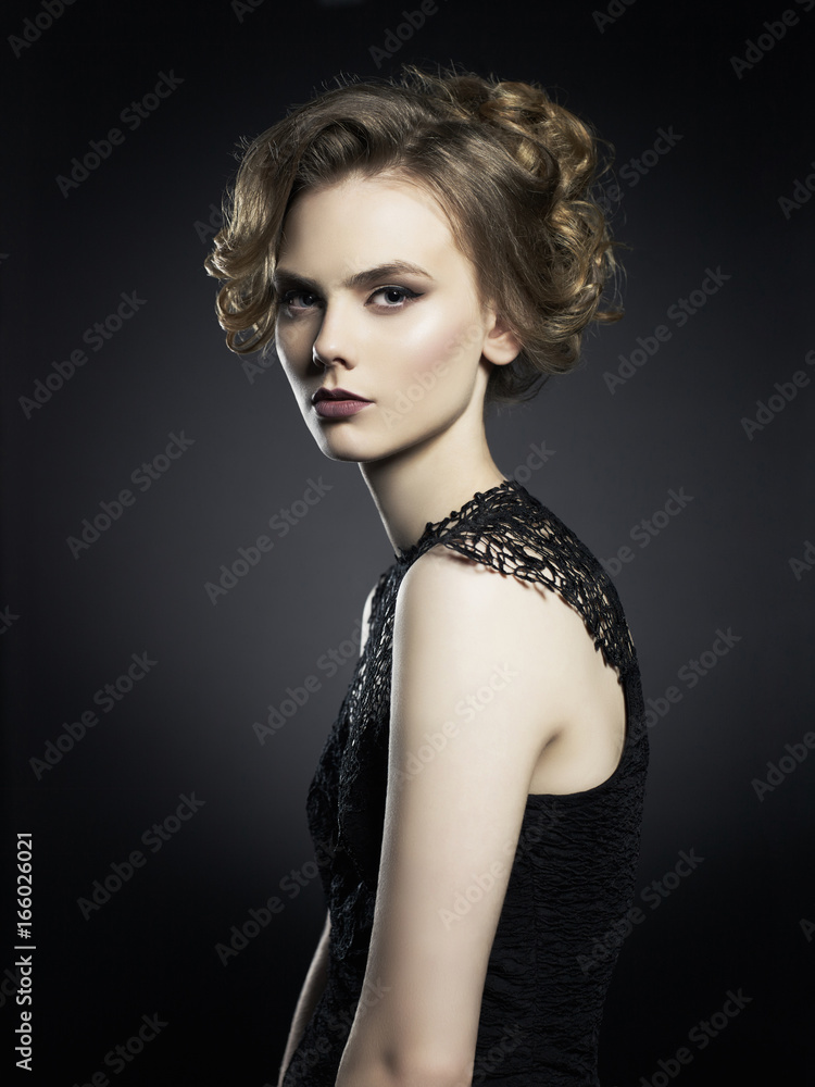 Fototapeta premium Beautiful young lady on black background