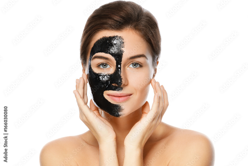 Beautiful woman with a black purifying mask on her face Stock Photo