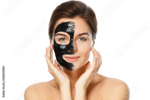 Beautiful woman with a black purifying mask on her face