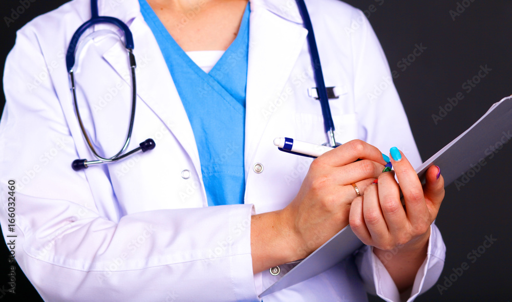 Woman doctor standing with folder at hospital Woman doctor standing with folder at hospital