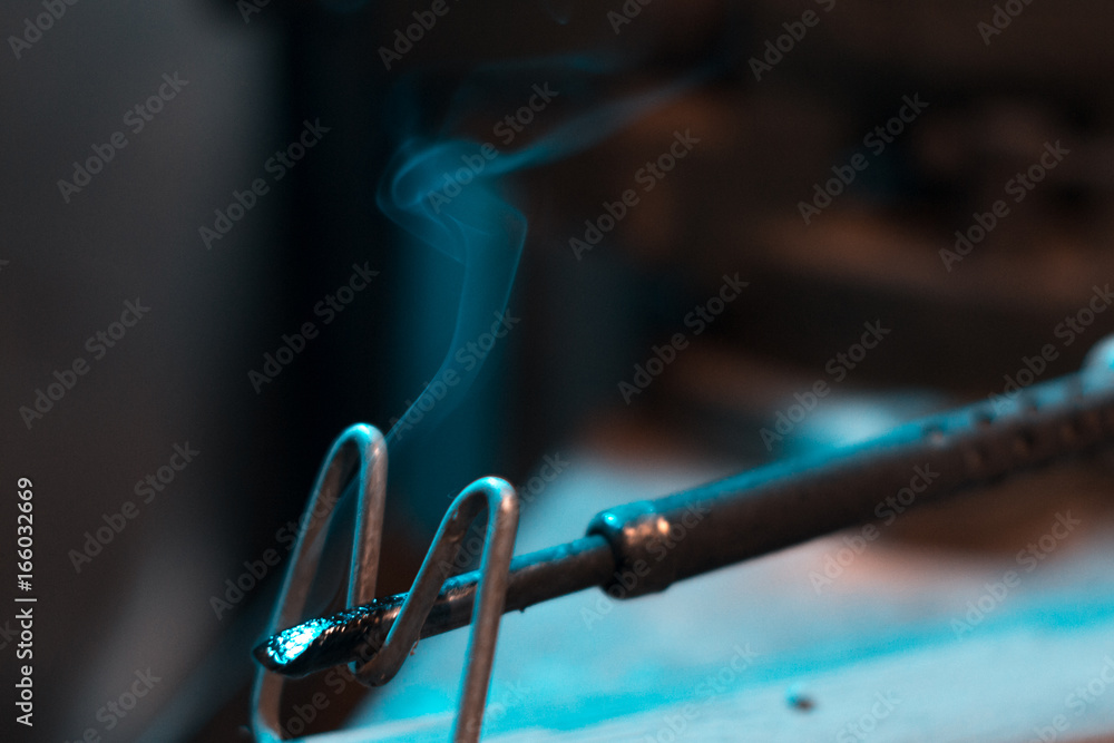 Old soldering iron in instrumental with blurred background. Old soldering iron in instrumental with blurred background.