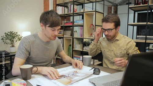 Designer shows the customer premises layout sketches. Prfessional photo