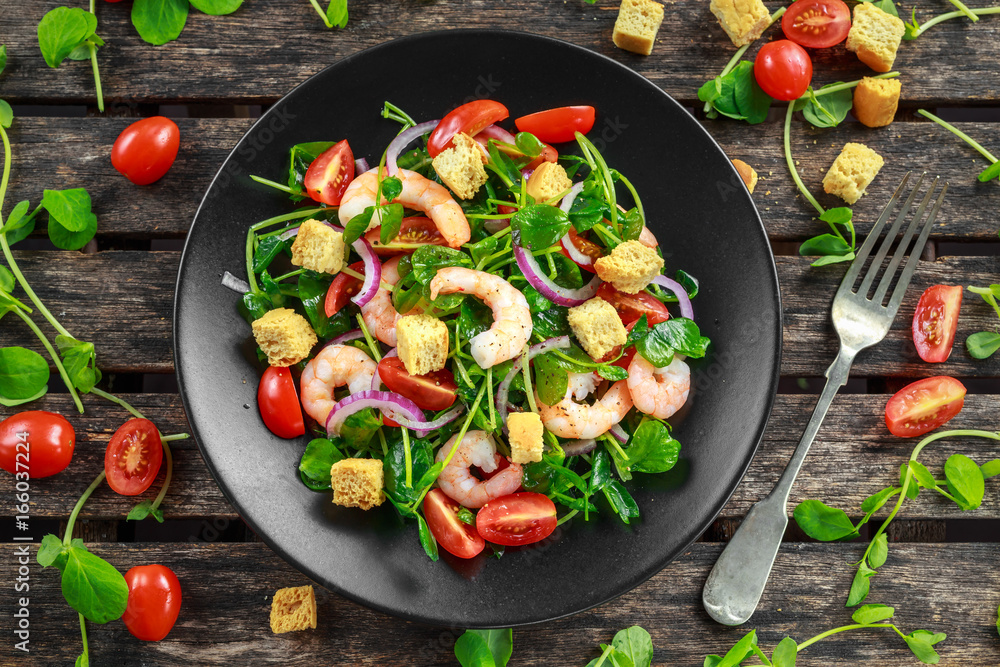 Fresh Healthy Prawns salad with tomatoes, red onion on black plate. concept healthy food Fresh Healthy Prawns salad with tomatoes, red onion on black plate. concept healthy food