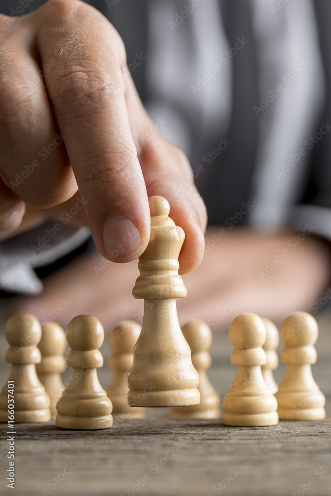Man playing chess moving the queen piece Man playing chess moving the queen piece