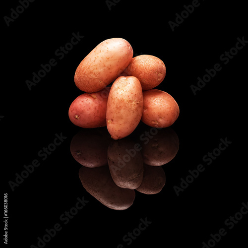 Pile of rose potatoes isolated on black