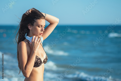 Young woman listen music at the beach.
