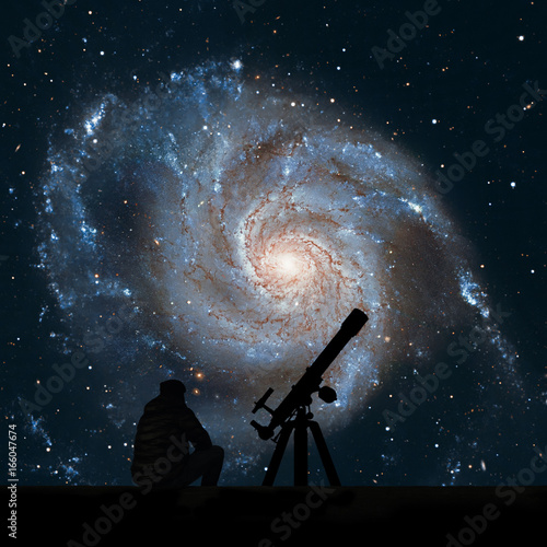 Man with telescope looking at the stars. Pinwheel Galaxy Messier 101, M101 in the constellation Ursa Major. photo