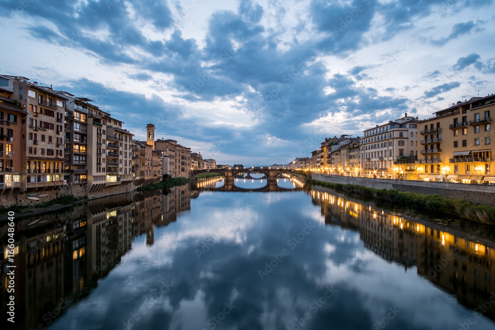 View of the Bridge and Building along Arno river in Florence, Italy. At night.