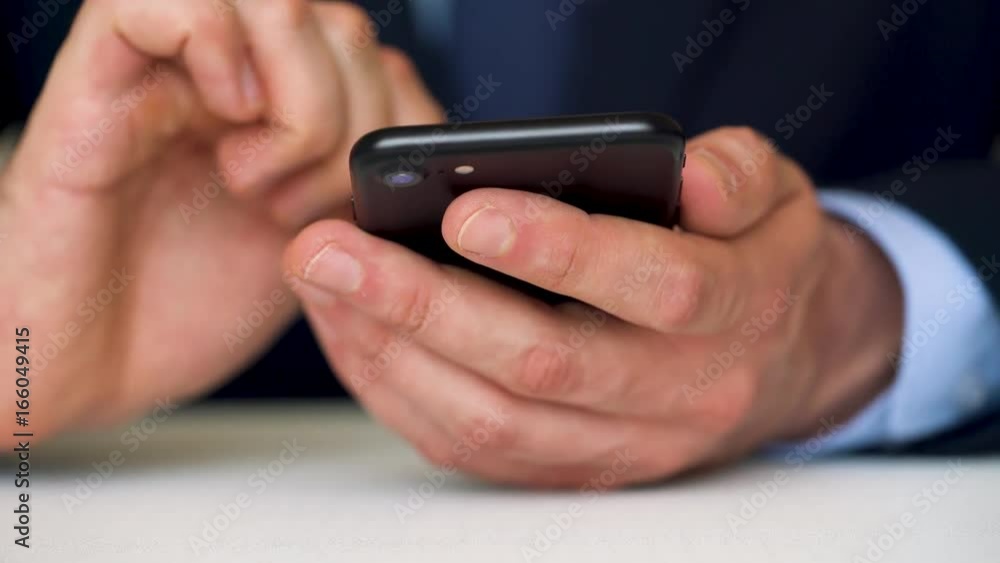 Businessman using smartphone for text messaging Businessman using smartphone for text messaging