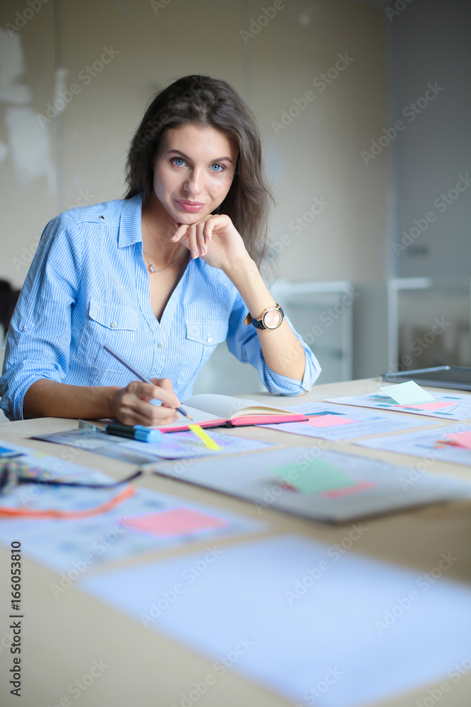 Young woman sitting at office table . Young woman. Young woman sitting at office table . Young woman.
