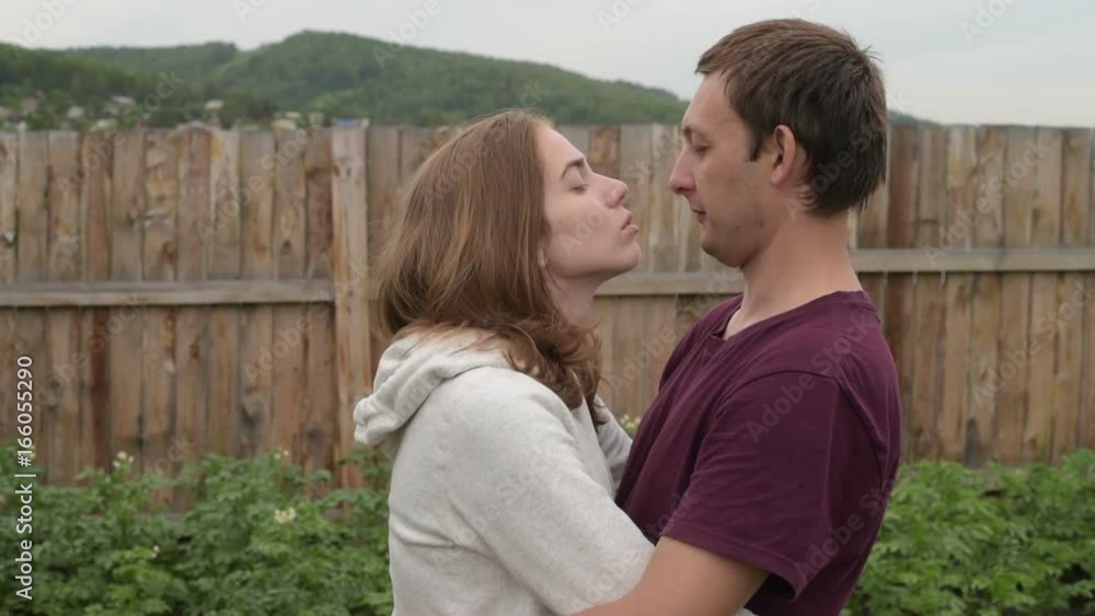 Man and woman kiss each other