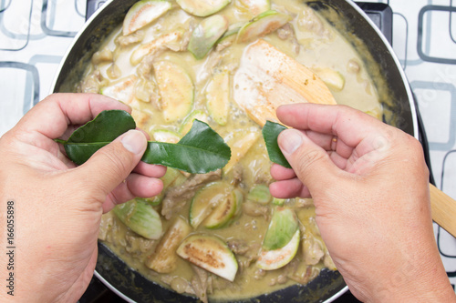 Chef shred kaffir lime leaves for cooking green curry