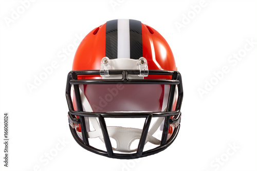 Sports and athletic training concept with front view of a red or orange american football helmet with black and grey stripe along the crown, isolated on a white background with clipping path
