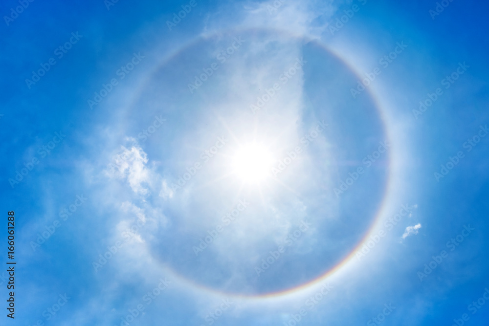 Low angle view of sun halo with circular rainbow in sky