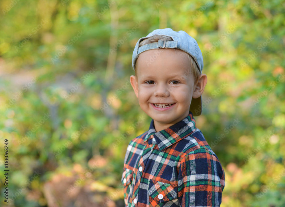 happy boy in autumn forest
