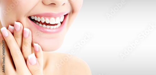 Closeup shot of happily laughing pretty woman against a grey background with copyspace