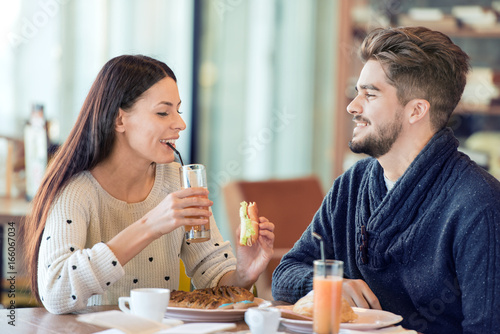 Happy couple having breakfast in cafe