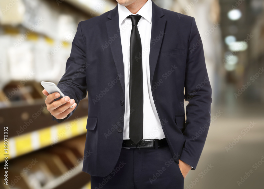 Businessman holding phone in hand on white background