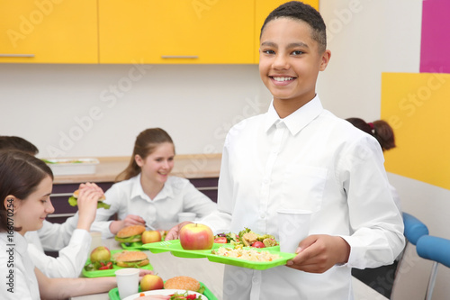 Cute boy holding tray with ...