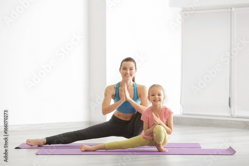 Mother and daughter doing exercise indoors
