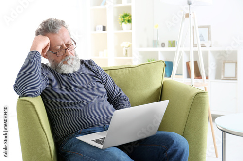 Handsome elderly man sittin...