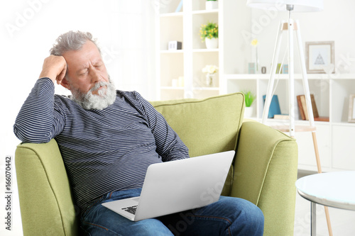 Handsome elderly man sittin...