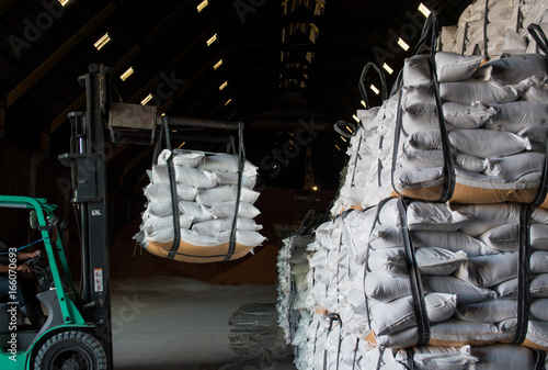 Sugar bags handling and shipping for export, forklift placing bags of sugar onto the stack. photo